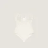 Body con spacchi in maglia con perle ricamate Body con spacchi in maglia con perle ricamate